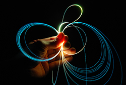 photo of fiber optic cables in a human hand